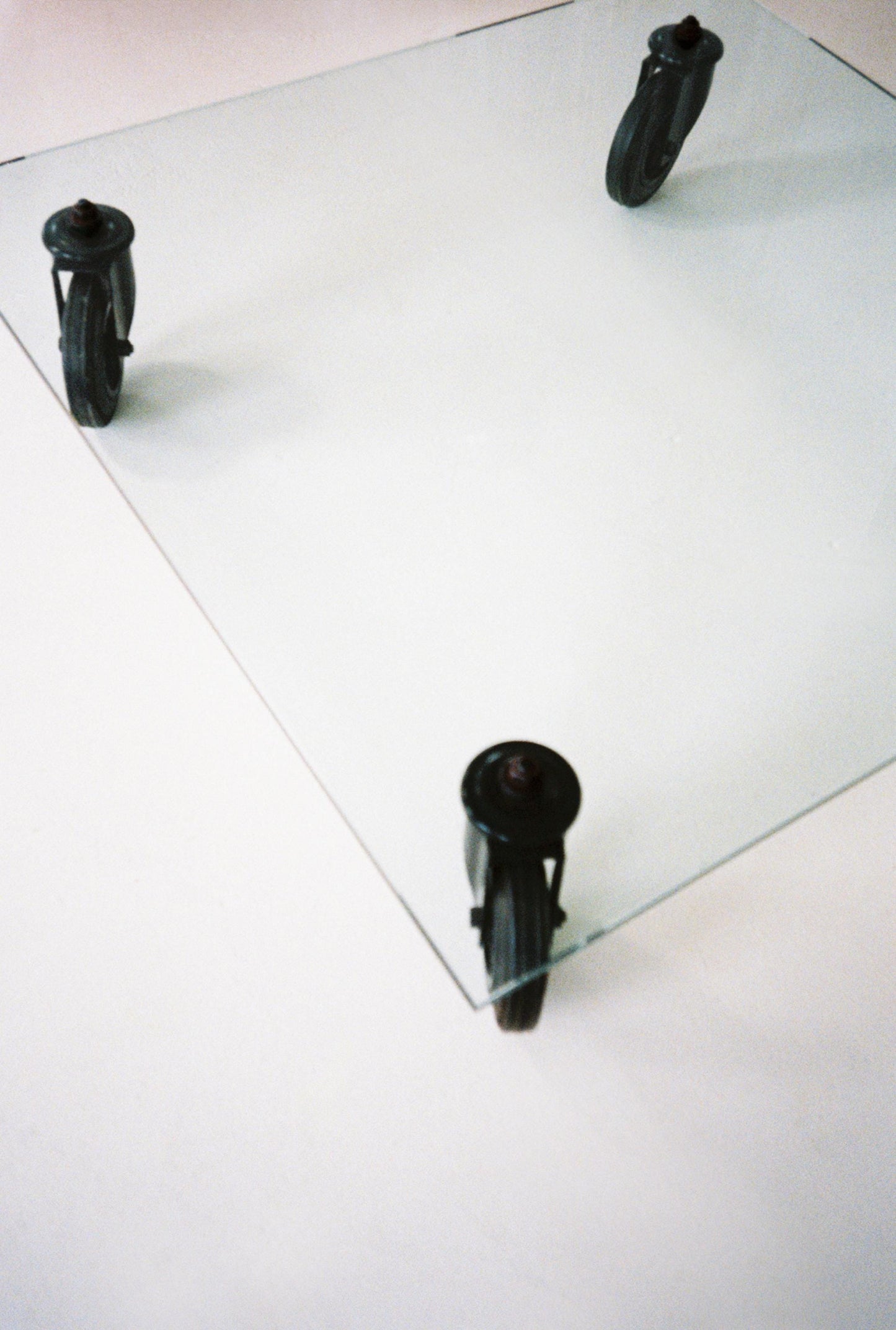 Gae Aulenti Glass Coffee Table with Industrial Cart Wheels, 1980s Fontana Arte